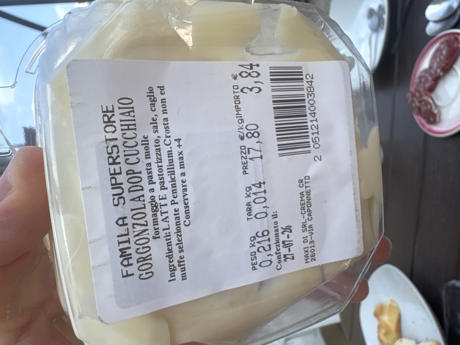 A 216-gram tub of Gorgonzola DOP al cucchiaio from the Famila supermarket in Crema, going soft on the terrace table