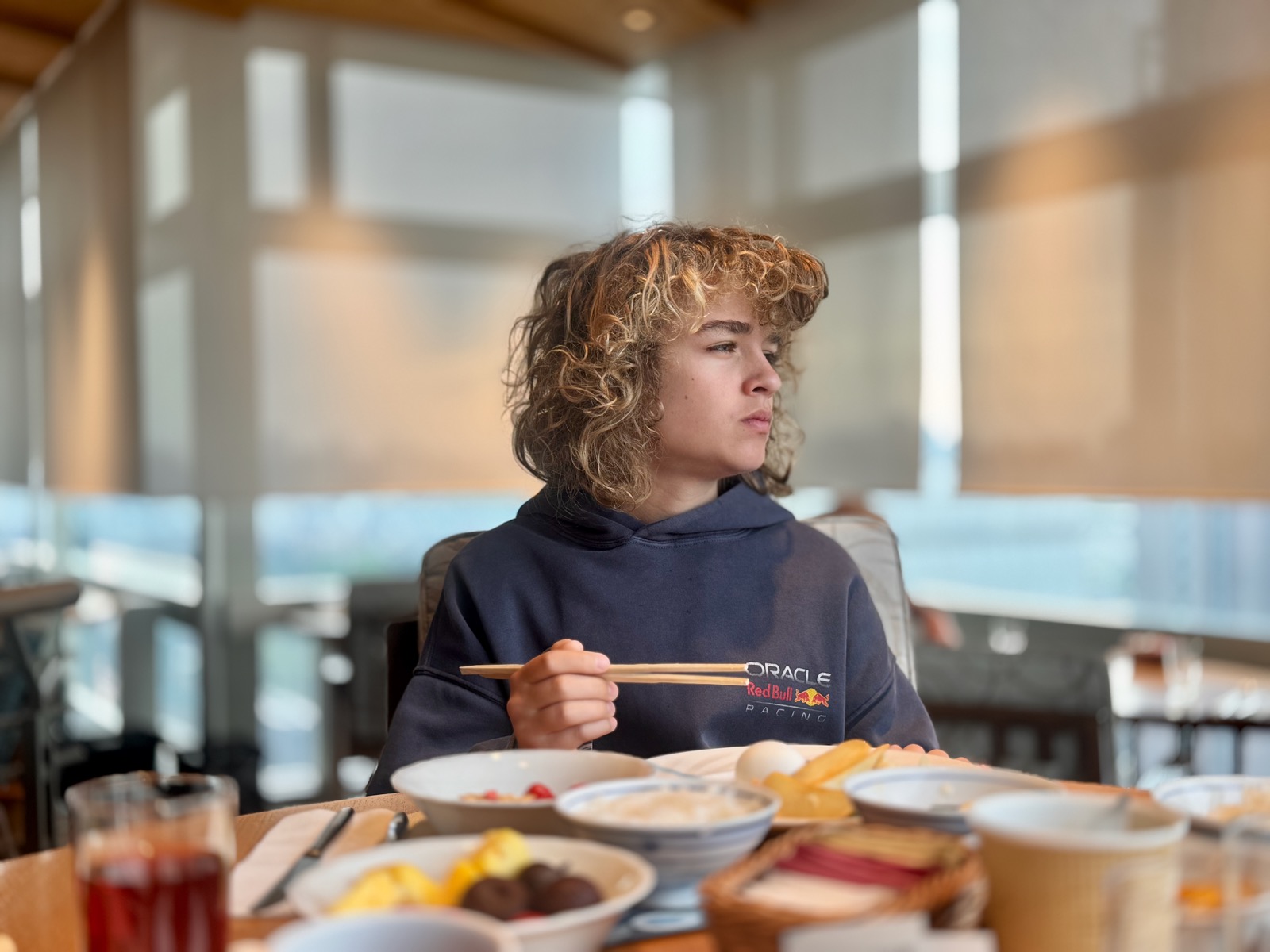 Luca eating breakfast with chopsticks at Southern Tower Dining