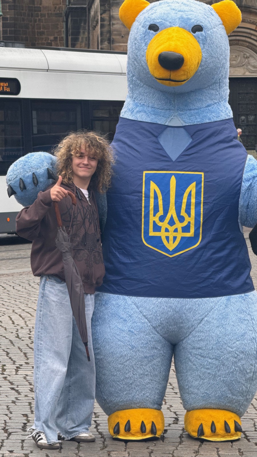 Luca thumbs-up with a giant Ukrainian bear by the Dom