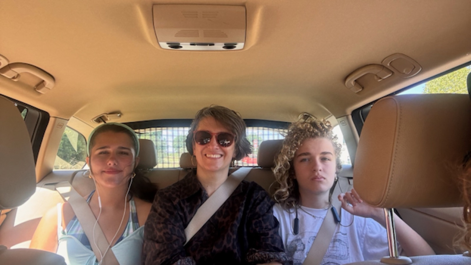 Three in the back seat, beach-bound