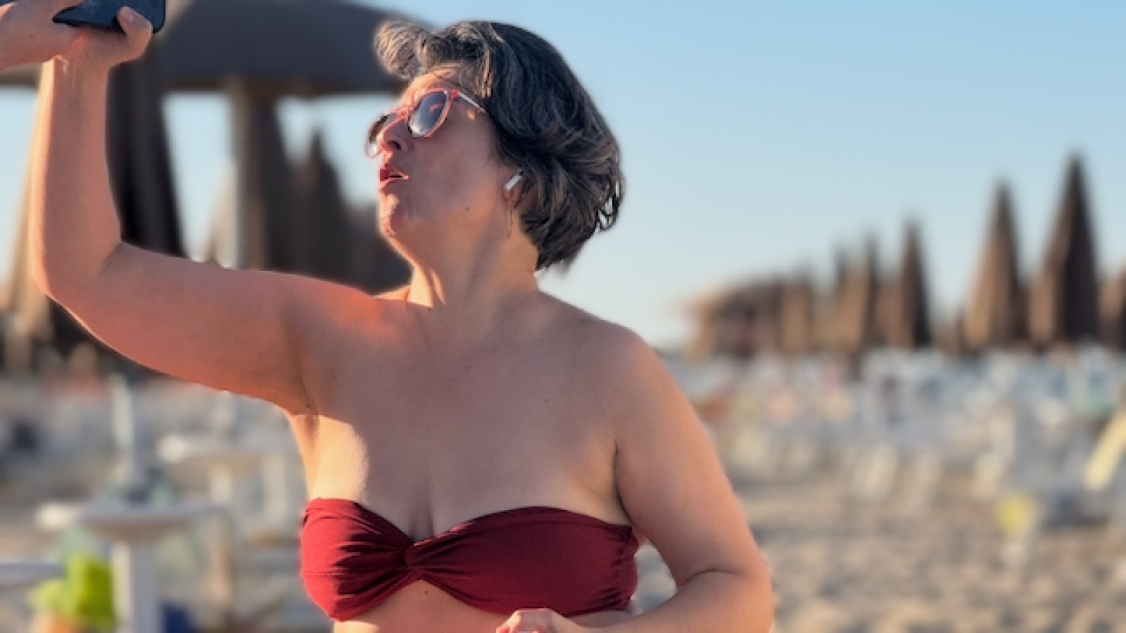 Natalia at golden hour among the closed umbrellas, Lido Adriano