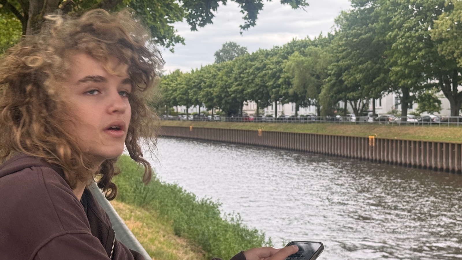 Luca windblown at the canal railing