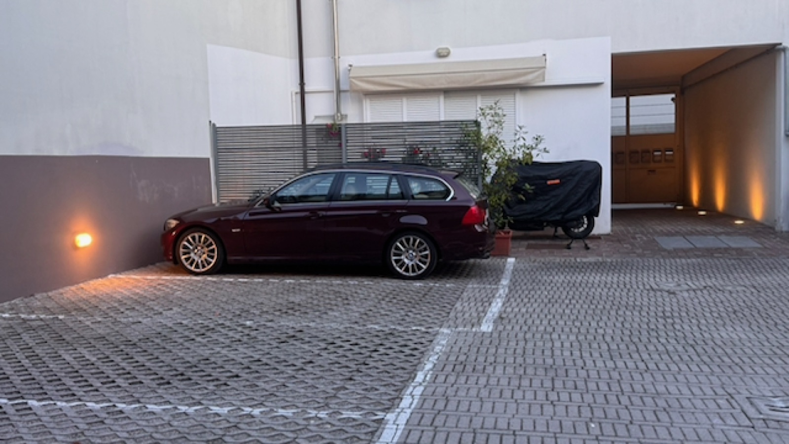 The car parked in the space marked X in the Casa Alighieri courtyard — exactly as instructed
