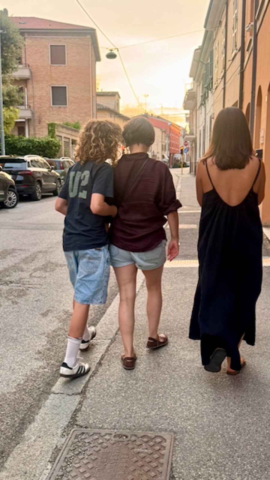 The three walking into the sunset on a Ravenna street, arms around each other